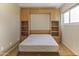 Bedroom features a built-in Murphy bed with shelving and drawers, plus a large window at 3345 E University Dr # 2, Mesa, AZ 85213