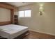 Bedroom featuring wood floors, a bed, and a large window at 3345 E University Dr # 2, Mesa, AZ 85213
