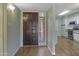 The hallway extends into the kitchen, which is lit by recessed lights at 3345 E University Dr # 2, Mesa, AZ 85213