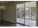 View from the living room to the patio with floor to ceiling glass doors at 3345 E University Dr # 2, Mesa, AZ 85213