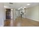 Open concept living area features wood flooring, a ceiling fan, and a bright kitchen at 3345 E University Dr # 2, Mesa, AZ 85213