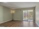 Bright living room with wood floors, a ceiling fan, and sliding glass door at 3345 E University Dr # 2, Mesa, AZ 85213
