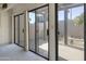 Enclosed patio with several floor to ceiling glass doors looking to the backyard at 3345 E University Dr # 2, Mesa, AZ 85213