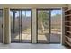 Enclosed patio with several floor to ceiling glass doors looking to the backyard at 3345 E University Dr # 2, Mesa, AZ 85213