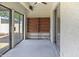 Enclosed patio with full wall of glass doors and a built in wooden bookcase at 3345 E University Dr # 2, Mesa, AZ 85213