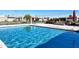 Community pool view with clear water and a seating area surrounded by landscaping at 3345 E University Dr # 2, Mesa, AZ 85213