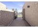 Charming walkway leads to a gated entrance with a view of the neighborhood street at 3345 E University Dr # 2, Mesa, AZ 85213