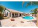 Private backyard with a sparkling pool, concrete patio, and mature landscaping for relaxation and recreation at 3550 E Topeka Dr, Phoenix, AZ 85050