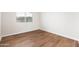 Bright bedroom featuring stylish wood flooring and a window offering natural light at 3550 E Topeka Dr, Phoenix, AZ 85050