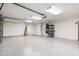 Bright, clean garage with epoxy floor, cabinets, and ample storage space for vehicles and more at 3550 E Topeka Dr, Phoenix, AZ 85050