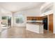 Open kitchen with island and stainless appliances, flowing into the dining area at 3550 E Topeka Dr, Phoenix, AZ 85050