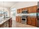 Kitchen features stainless steel appliances, granite countertops and ample storage at 3550 E Topeka Dr, Phoenix, AZ 85050