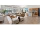 Inviting living room open to the kitchen with stylish furniture, neutral tones, and bright natural light at 3550 E Topeka Dr, Phoenix, AZ 85050