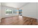 Open living room with wood floors, large windows, and sliding doors leading to the pool at 3550 E Topeka Dr, Phoenix, AZ 85050