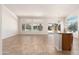 Bright living room featuring tile floors and large windows overlooking a pool at 3550 E Topeka Dr, Phoenix, AZ 85050