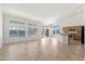 Bright open-concept living area with kitchen view, tile flooring, large windows, and high ceilings at 3550 E Topeka Dr, Phoenix, AZ 85050