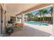 Cozy covered patio overlooking a sparkling pool and lush greenery, perfect for outdoor relaxation at 3550 E Topeka Dr, Phoenix, AZ 85050