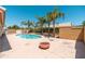 Refreshing pool surrounded by desert landscaping and palm trees creating a serene outdoor oasis at 3550 E Topeka Dr, Phoenix, AZ 85050