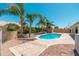 Backyard pool with palm trees and desert landscaping, perfect for relaxing and entertaining at 3550 E Topeka Dr, Phoenix, AZ 85050