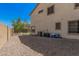 Home exterior featuring a gravel area, air conditioning units, and a fenced perimeter for privacy at 3625 W South Butte Rd, San Tan Valley, AZ 85144
