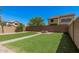 Well-maintained backyard featuring artificial grass, a fire pit, and privacy fencing at 3625 W South Butte Rd, San Tan Valley, AZ 85144