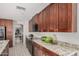 Open kitchen featuring granite countertops and dark wood cabinets with stainless steel microwave at 3625 W South Butte Rd, San Tan Valley, AZ 85144