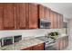 Updated kitchen boasting dark wood cabinets, granite countertops and modern appliances at 3625 W South Butte Rd, San Tan Valley, AZ 85144