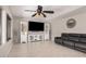 Spacious living room with tiled floors, modern TV console, and ceiling fan at 3625 W South Butte Rd, San Tan Valley, AZ 85144