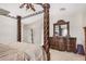 Bedroom featuring ornate four-poster bed, dresser, and neutral carpet at 3625 W South Butte Rd, San Tan Valley, AZ 85144
