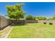 An expansive grassy backyard framed by a block wall and lush trees at 38191 W Merced St, Maricopa, AZ 85138