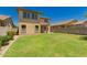Lush backyard with green grass and block fencing is ideal for outdoor activities at 38191 W Merced St, Maricopa, AZ 85138