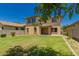 Large grassy backyard featuring a two-story house and an outdoor space at 38191 W Merced St, Maricopa, AZ 85138