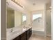 Bathroom features double sinks, large tub, and separate glass-enclosed shower at 38191 W Merced St, Maricopa, AZ 85138