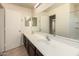 Bathroom with double sink vanity, large mirror, and modern fixtures offers practicality at 38191 W Merced St, Maricopa, AZ 85138