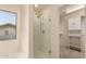 Glass-enclosed shower features chrome fixtures and a view to the walk-in closet at 38191 W Merced St, Maricopa, AZ 85138