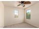 Bedroom featuring a ceiling fan and two windows, creating a comfortable atmosphere at 38191 W Merced St, Maricopa, AZ 85138