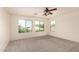 Bright bedroom with large windows and plush carpeting for natural light and comfort at 38191 W Merced St, Maricopa, AZ 85138