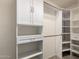 Walk-in closet with custom shelving, drawers, and ample storage space at 38191 W Merced St, Maricopa, AZ 85138