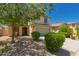 Attractive two-story home with a tidy front yard, mature trees, and a convenient two-car garage at 38191 W Merced St, Maricopa, AZ 85138