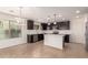 Well-appointed kitchen featuring stainless steel appliances, dark cabinetry, and a center island at 38191 W Merced St, Maricopa, AZ 85138