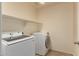 Laundry room featuring newer washer and dryer units, with shelving for storage at 38191 W Merced St, Maricopa, AZ 85138
