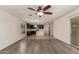 Inviting open-concept living space with a view into the kitchen and outdoor access at 38191 W Merced St, Maricopa, AZ 85138