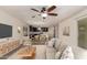 Inviting living room showcasing a modern design with an open layout into the kitchen and dining area at 38191 W Merced St, Maricopa, AZ 85138
