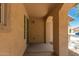 Covered front porch with classic archways offers a welcoming entrance to the home at 38191 W Merced St, Maricopa, AZ 85138