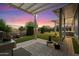 Backyard with artificial lawn, covered patio, and built in grill, perfect for outdoor cooking and entertaining at 42105 N Golf Crest Rd, Anthem, AZ 85086