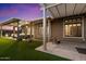 Well-maintained backyard featuring an artificial lawn, pergola, and covered patio for outdoor relaxation at 42105 N Golf Crest Rd, Anthem, AZ 85086