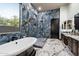 Luxurious bathroom featuring a soaking tub, walk-in shower, and elegant marble flooring at 42105 N Golf Crest Rd, Anthem, AZ 85086