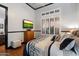 Comfortable bedroom features a golf scene on television and a plush bed with decorative pillows and a patterned comforter at 42105 N Golf Crest Rd, Anthem, AZ 85086
