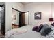 Spacious bedroom features hardwood floors, mirrored closet doors, a comfortable bed with plush pillows and a cozy throw at 42105 N Golf Crest Rd, Anthem, AZ 85086