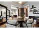 Open dining area with wood floors, neutral walls, wainscoting and a modern mirror at 42105 N Golf Crest Rd, Anthem, AZ 85086